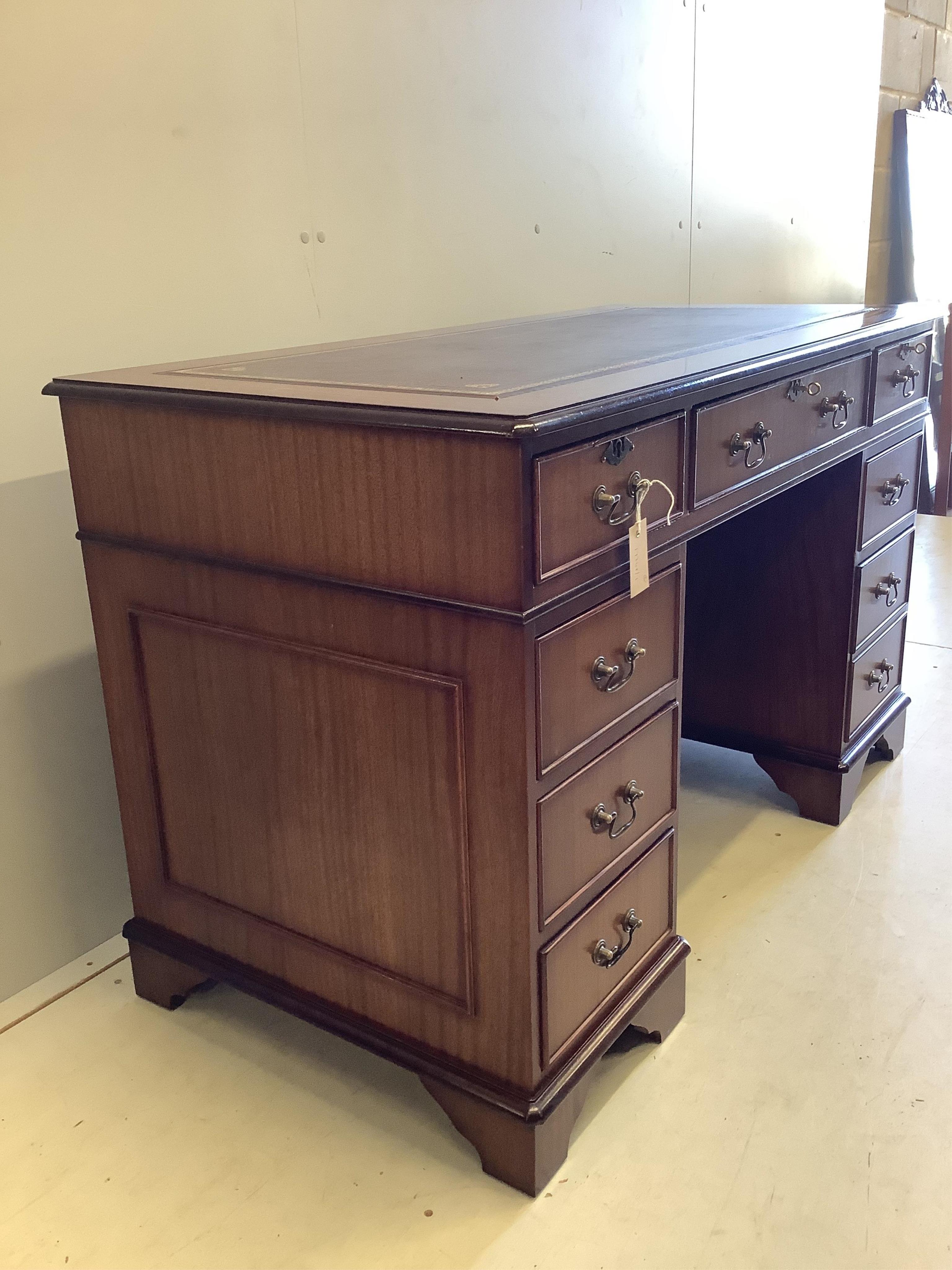 A reproduction Victorian style beech and burgundy leather swivel desk chair, together with a reproduction mahogany pedestal desk, width 121cm, depth 61cm, height 76cm